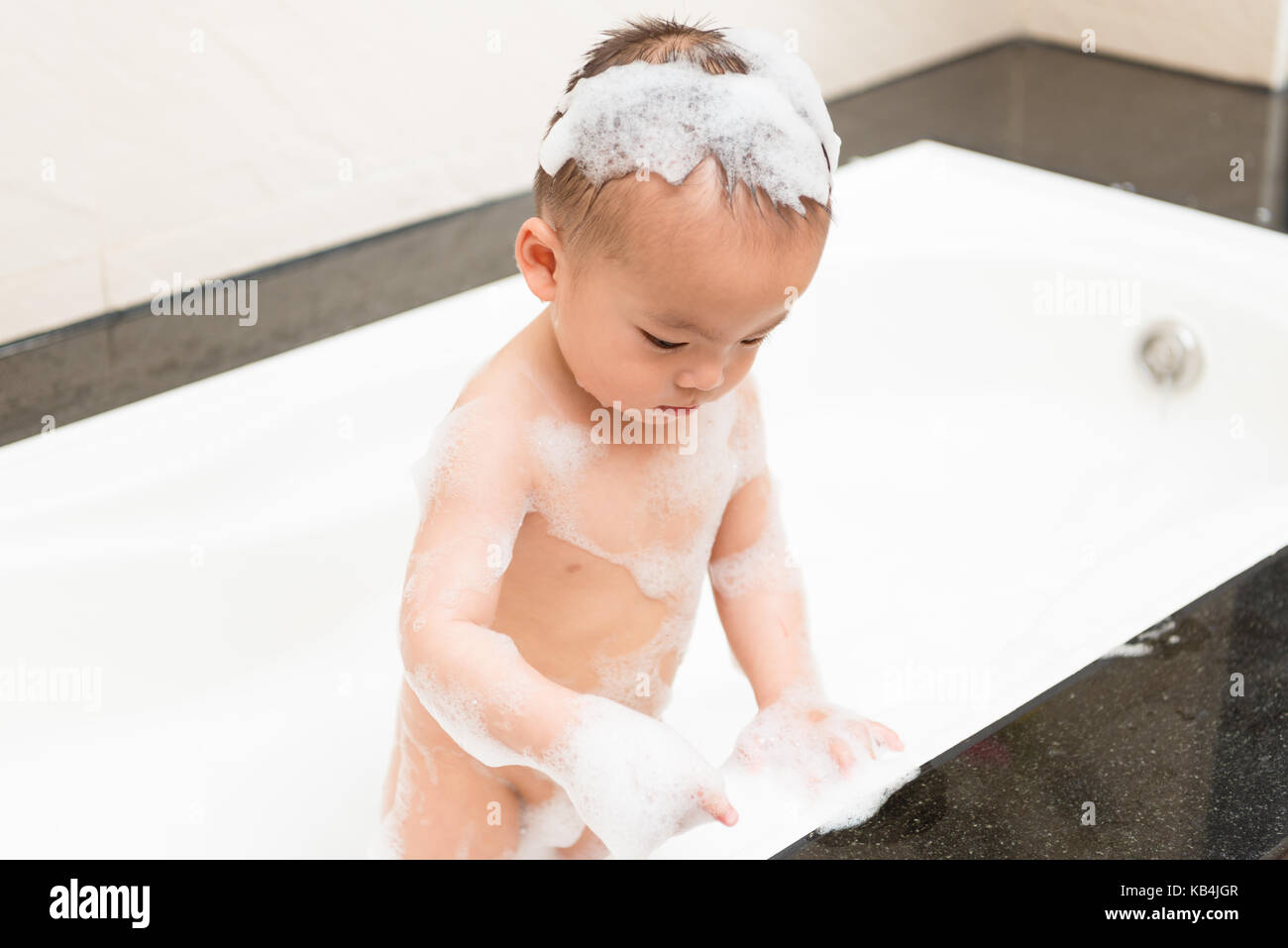 Boy standing in bath tub hires stock photography and images Alamy