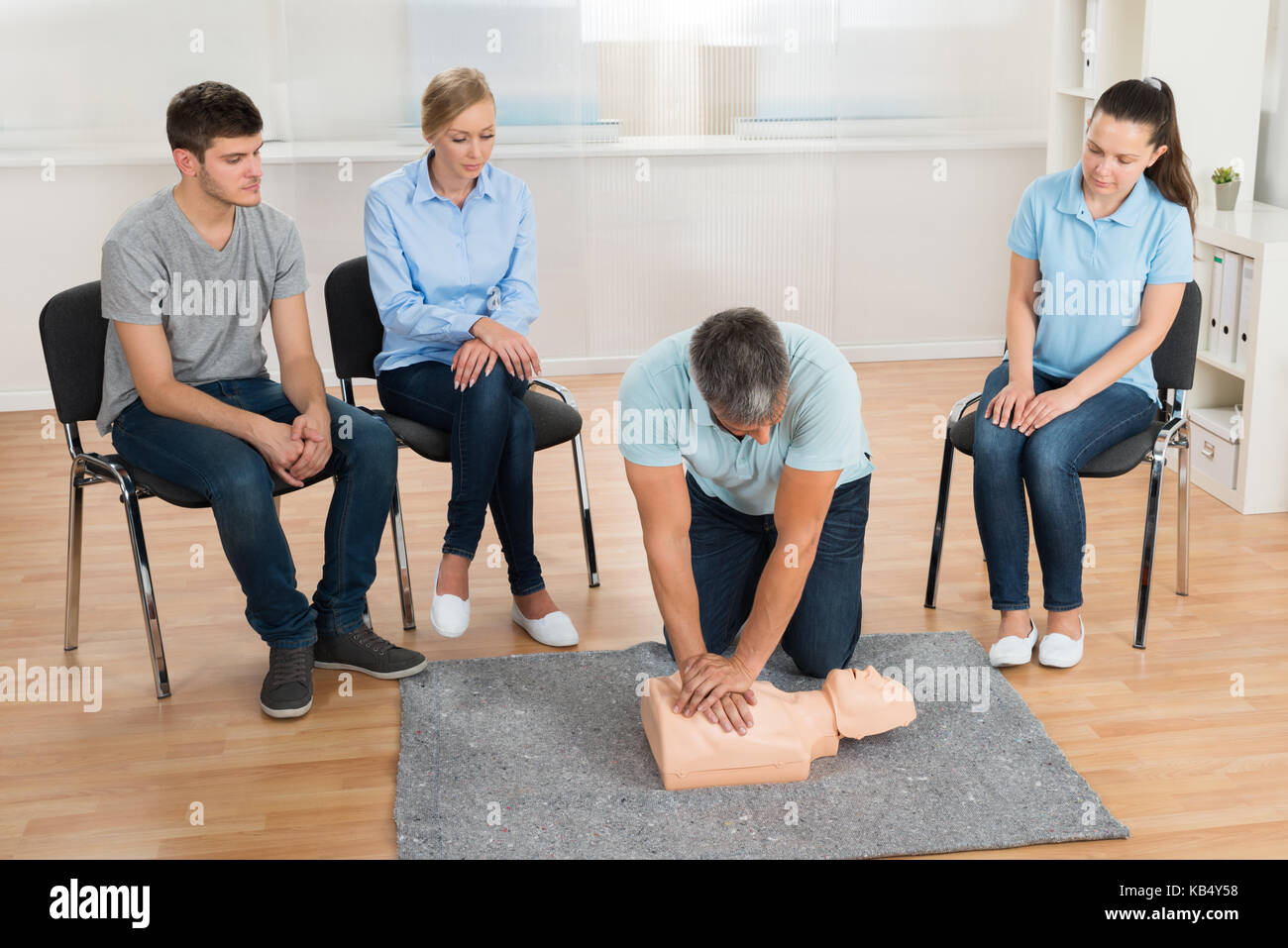 Male Instructor Teaching First Aid Cpr Technique To His Students Stock
