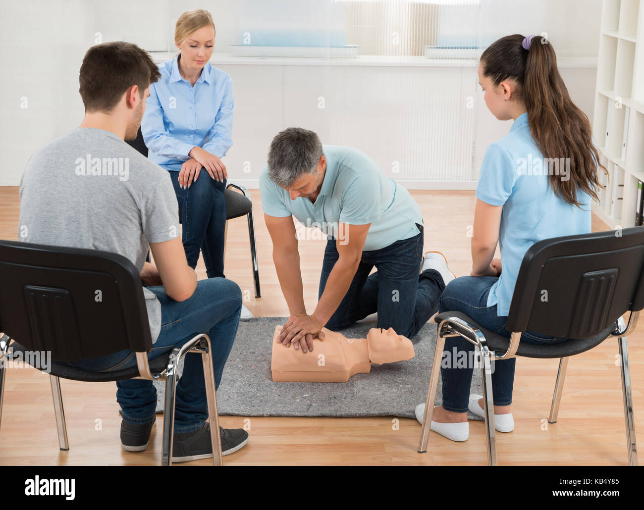 Male Instructor Teaching First Aid Cpr Technique To His Students Stock Photo