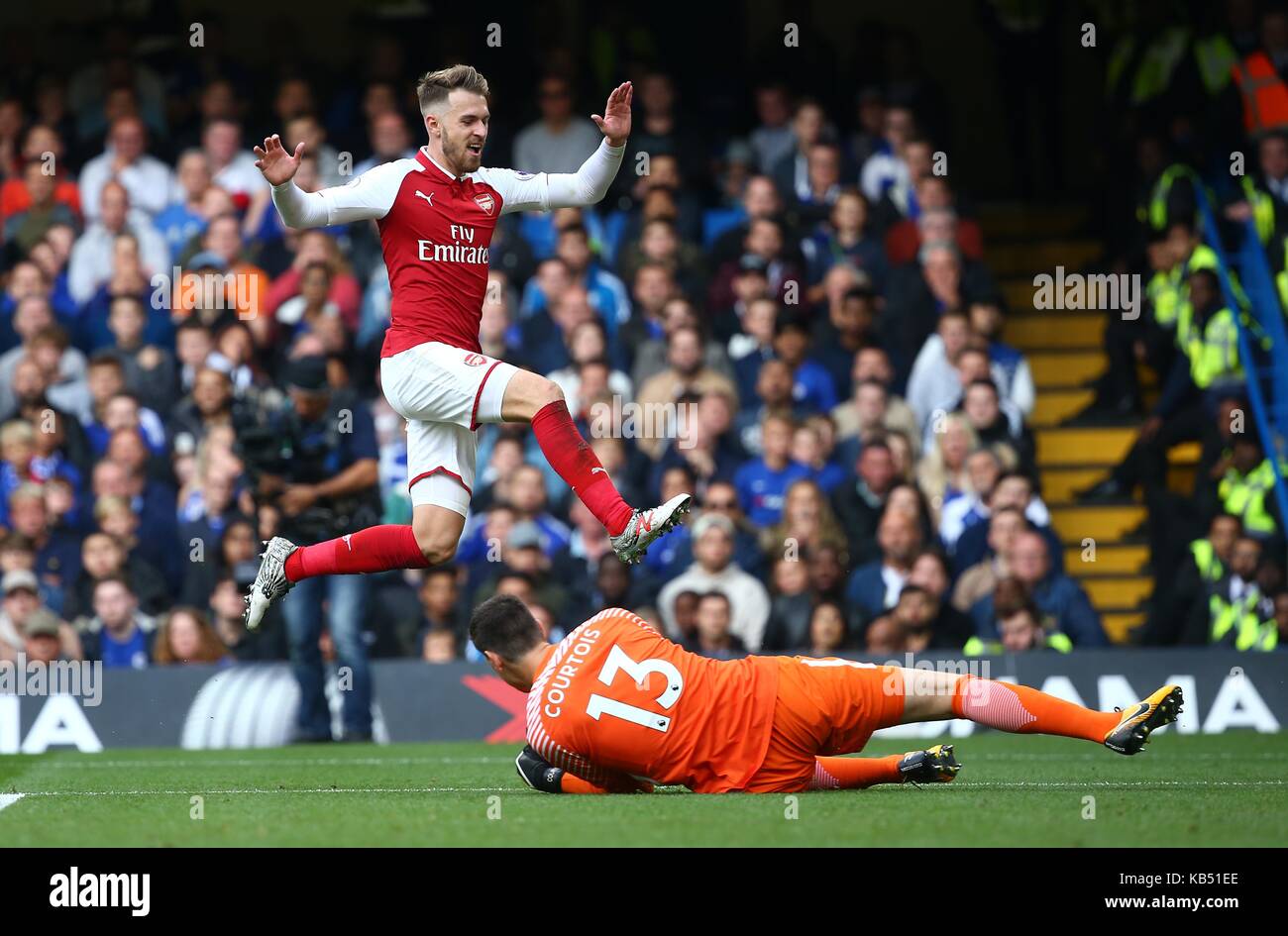 Aaron Ramsey of Arsenal and Thibaut Courtois of Chelsea during the Premier League match between Chelsea and Arsenal at Stamford Bridge in London. 17 Sep 2017 Stock Photo