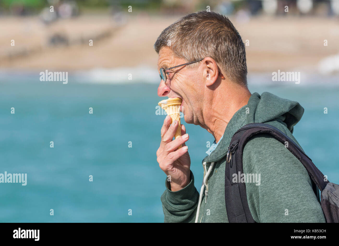 Middle aged man eating an ice cream cone. Stock Photo