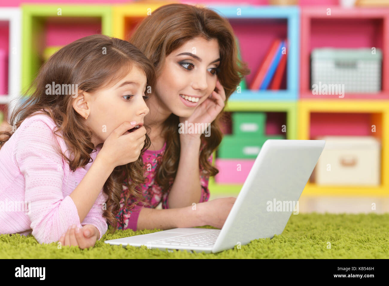 woman and little girl using laptop Stock Photo - Alamy