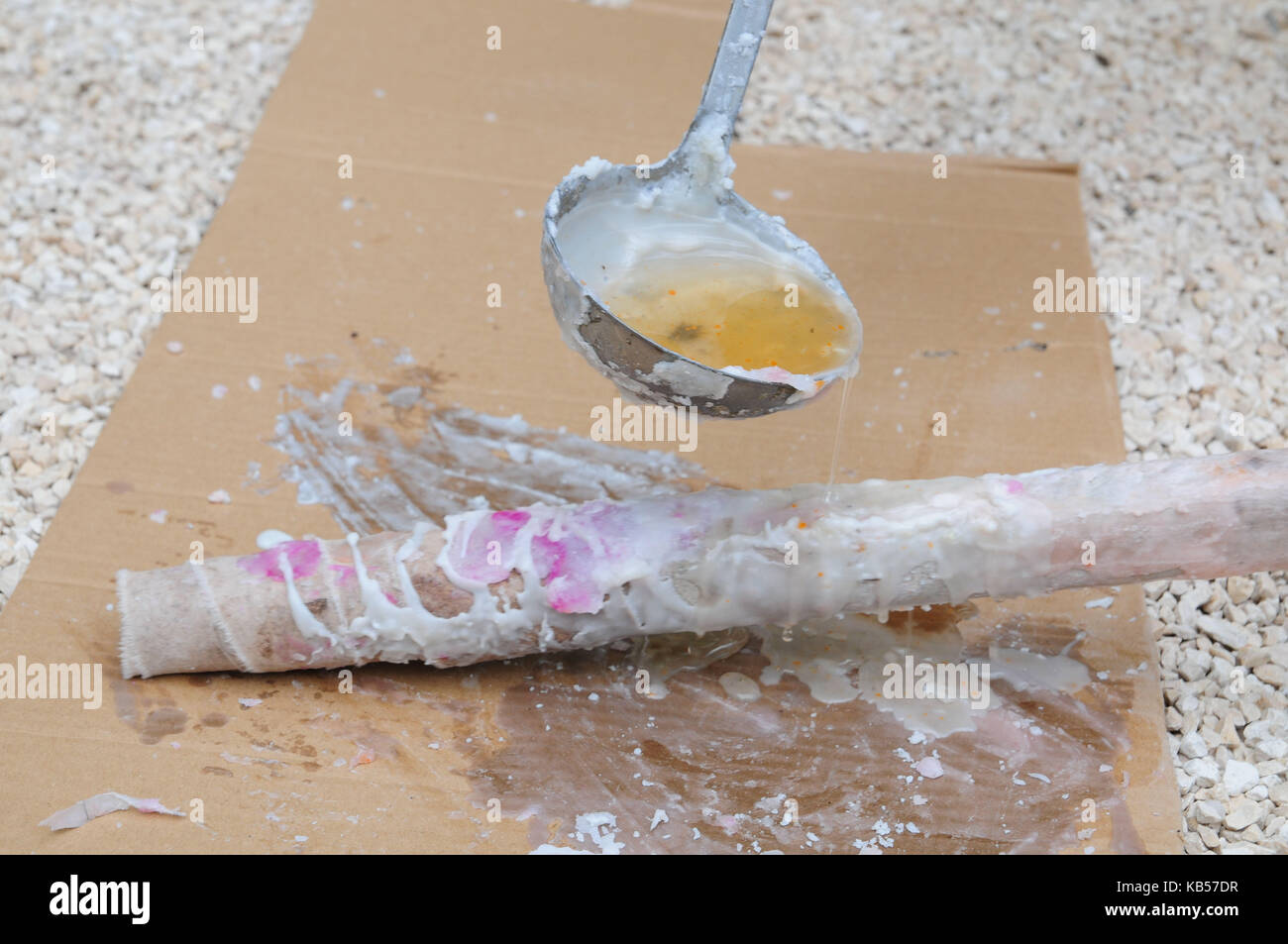 handicraft instruction, step by step, build torches by yourself, pour wax on torch with scoop, picture series with text Stock Photo