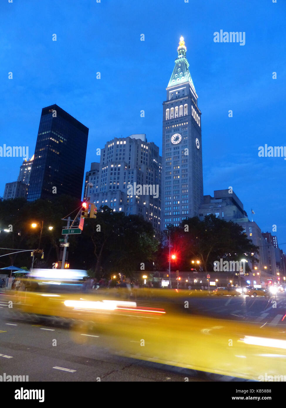 NYC, view of Fifth Avenue and 23rd Street intersection with passing yellow cabs with Madison Avenue office towers Stock Photo