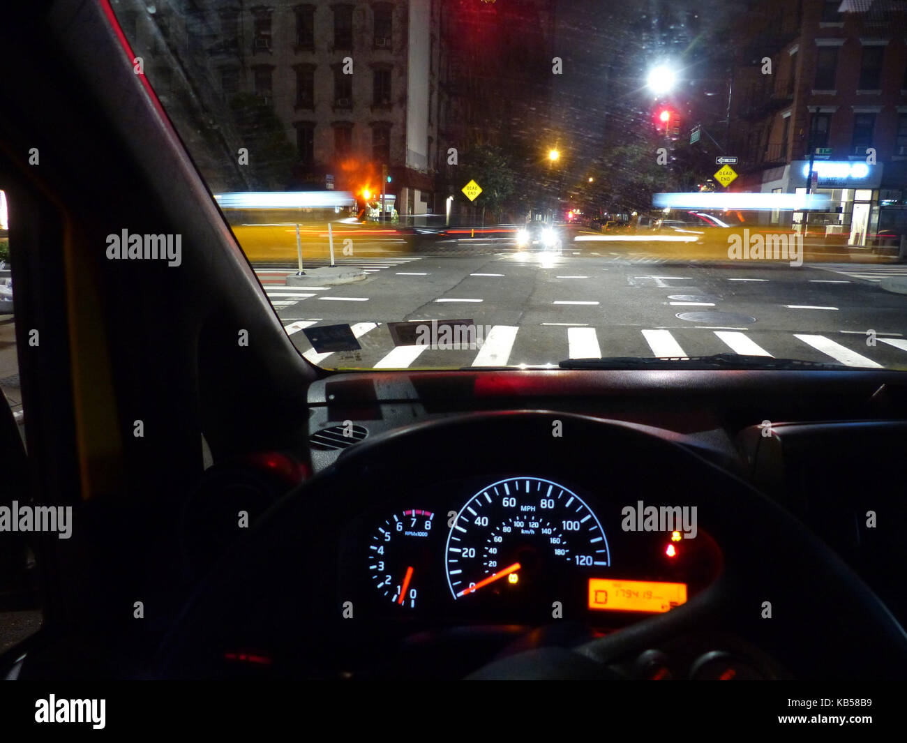 NYC, view of Upper Westside intersection with passing yellow cabs viewed threw the windshield Stock Photo