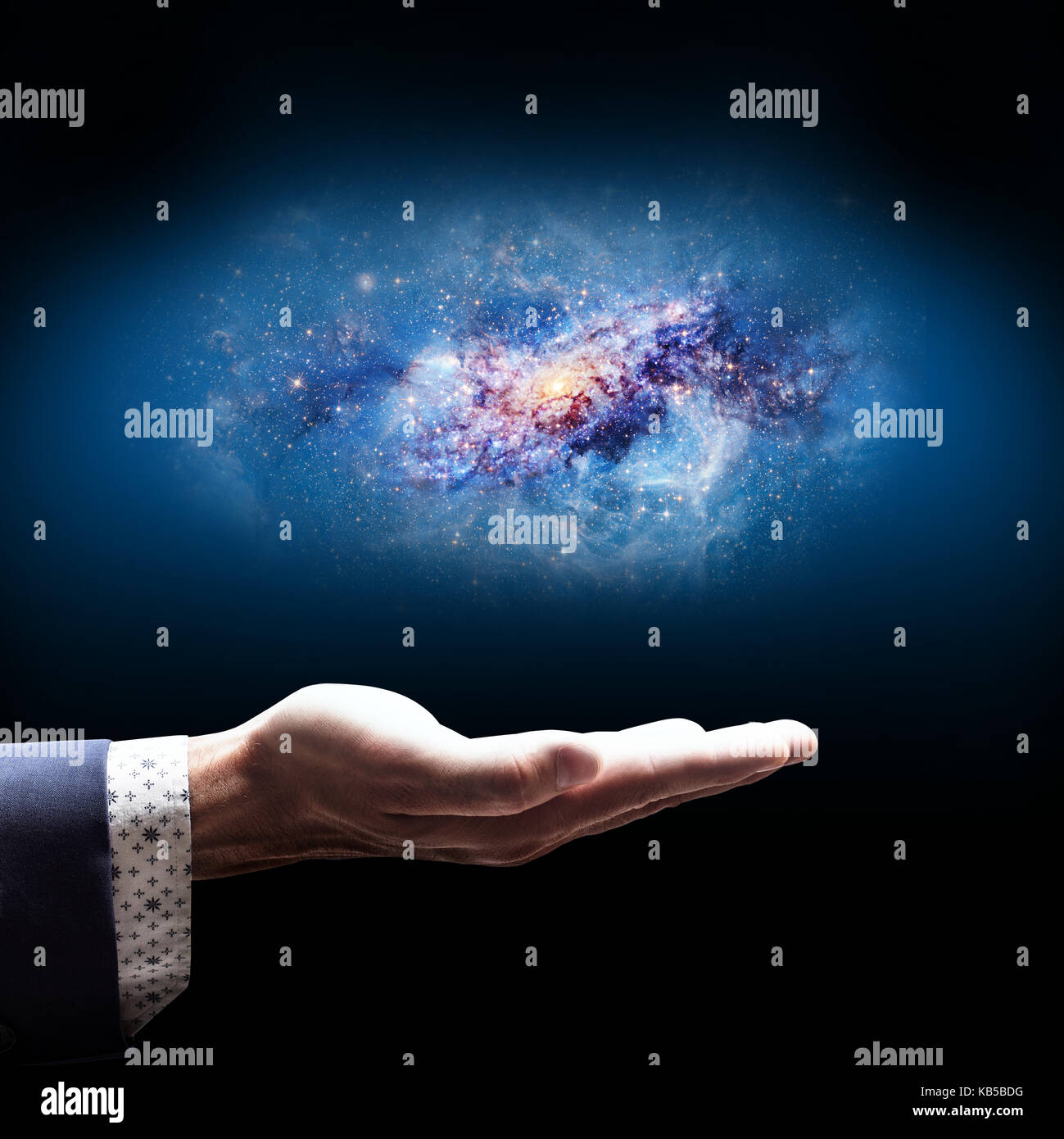 Businessman hand holding little galaxy Stock Photo Alamy