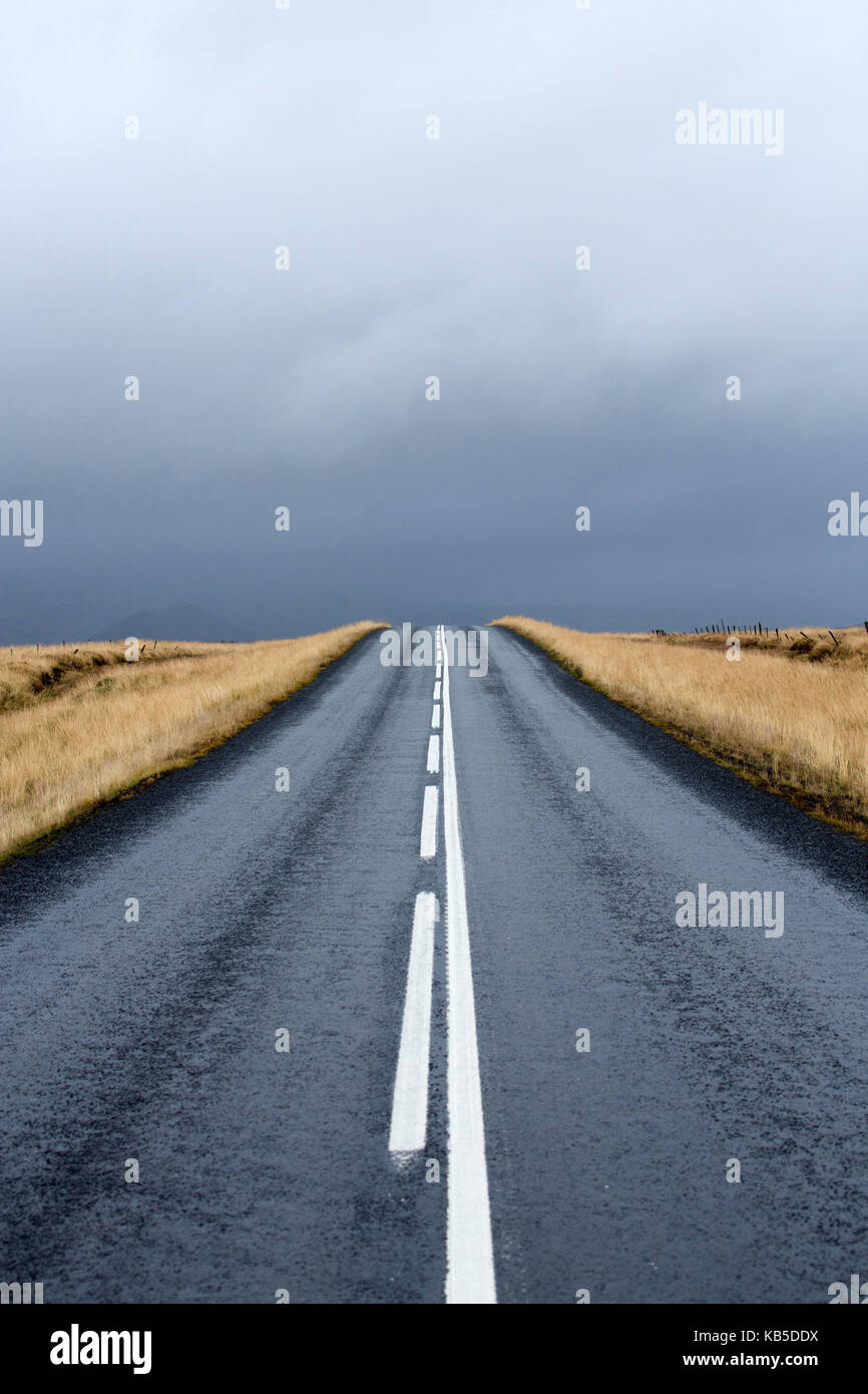 Road stretching away towards stormy sky, Snaefellsnes Peninsula, Iceland, Polar Regions Stock Photo