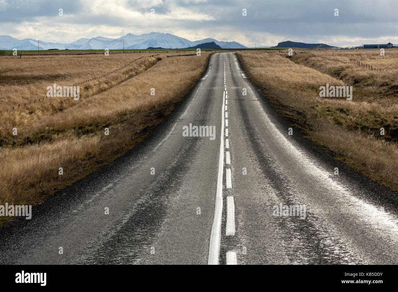 Road stretching away towards distant mountains, Snaefellsnes Peninsula, Iceland, Polar Regions Stock Photo