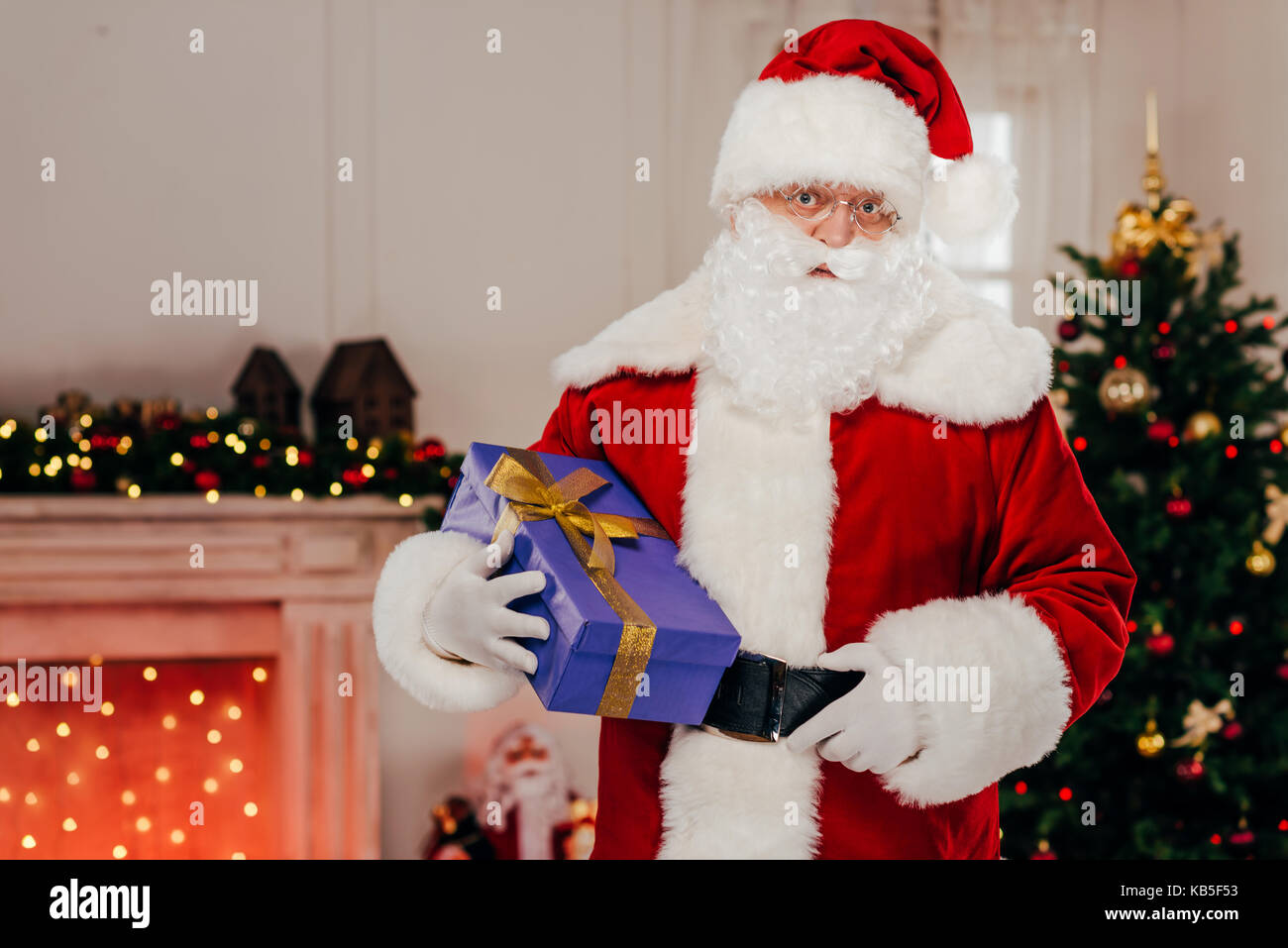 santa holding gift box Stock Photo - Alamy