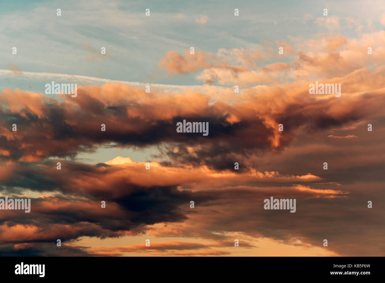 Dramatic orange clouds at sunset as natural background Stock Photo