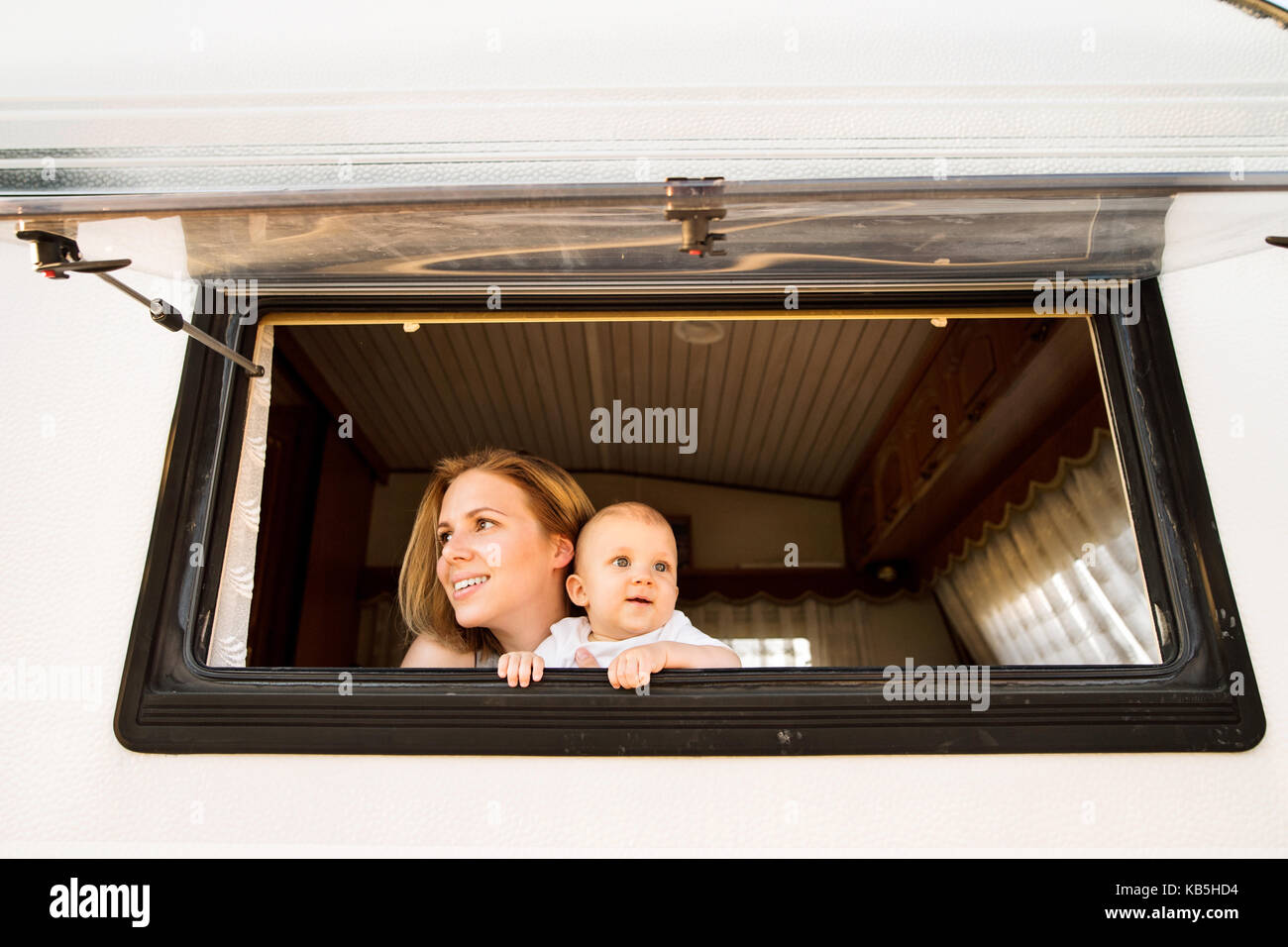Mother and baby son in a camper van. Stock Photo