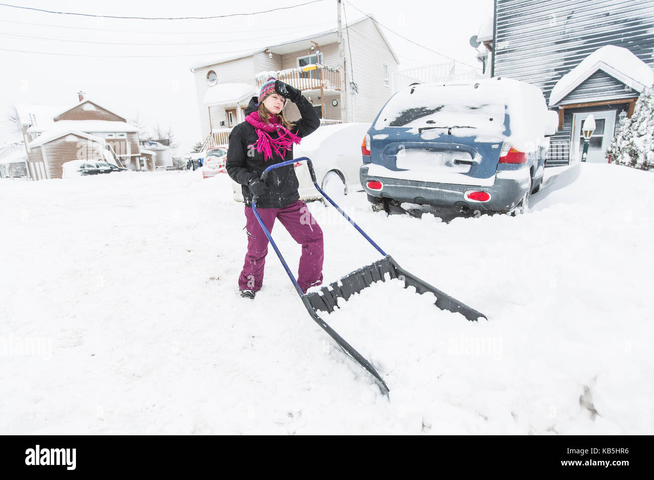 woman shoveling and removing snow outside Stock Photo - Alamy