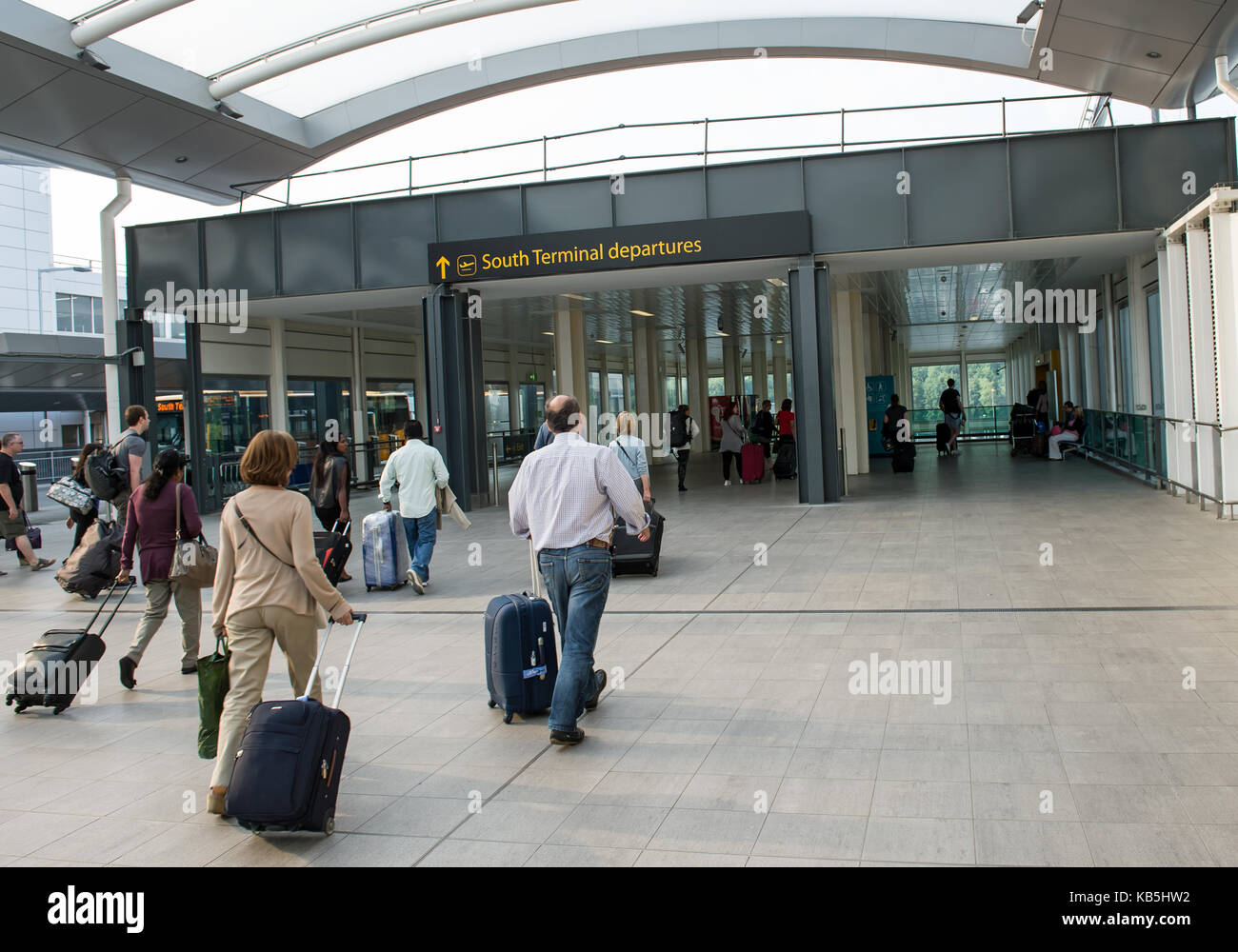 Passengers walk through the South Terminal entrance at Gatwick Stock Photo