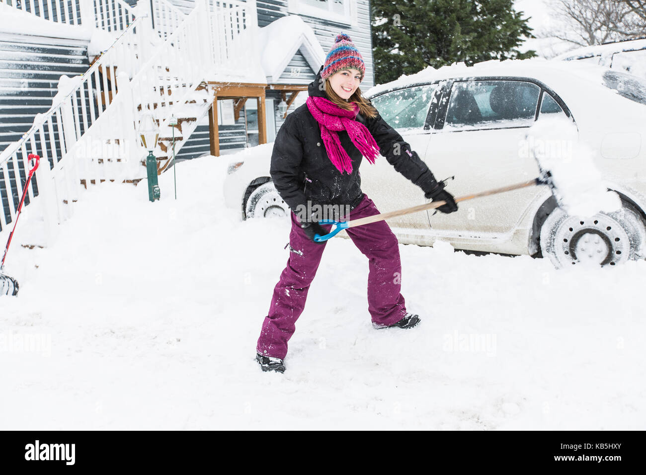 woman shoveling and removing snow outside Stock Photo - Alamy