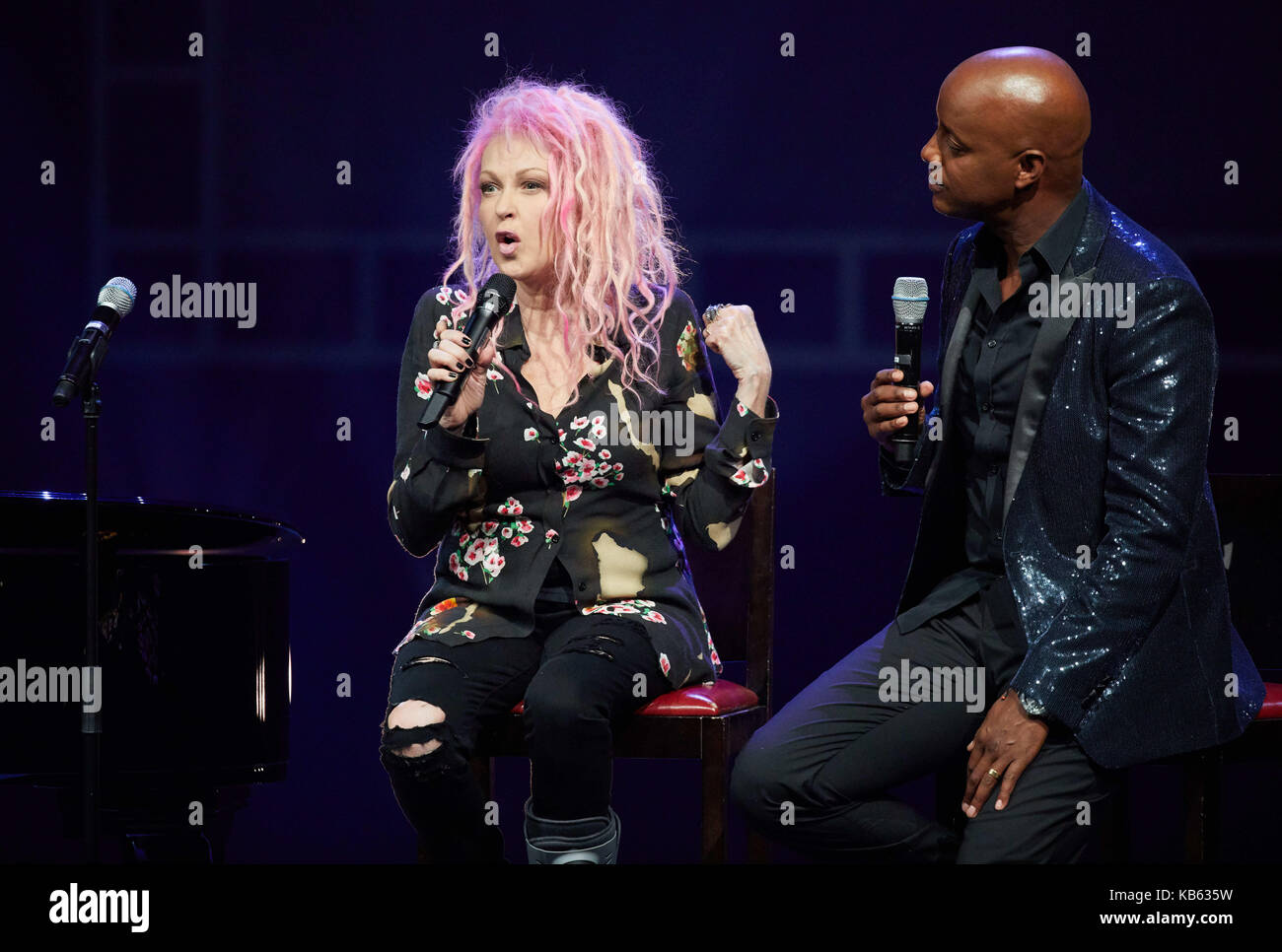 The singer Cyndi Lauper (L) and the moderator Yared Dibaba speak on stage of the Operettenhaus during a press showing of the musical 'Kinky Boots' in Hamburg, Germany, 28. September 2017. The Germany premiere will be on the 3rd of December. Photo: Georg Wendt/dpa Stock Photo