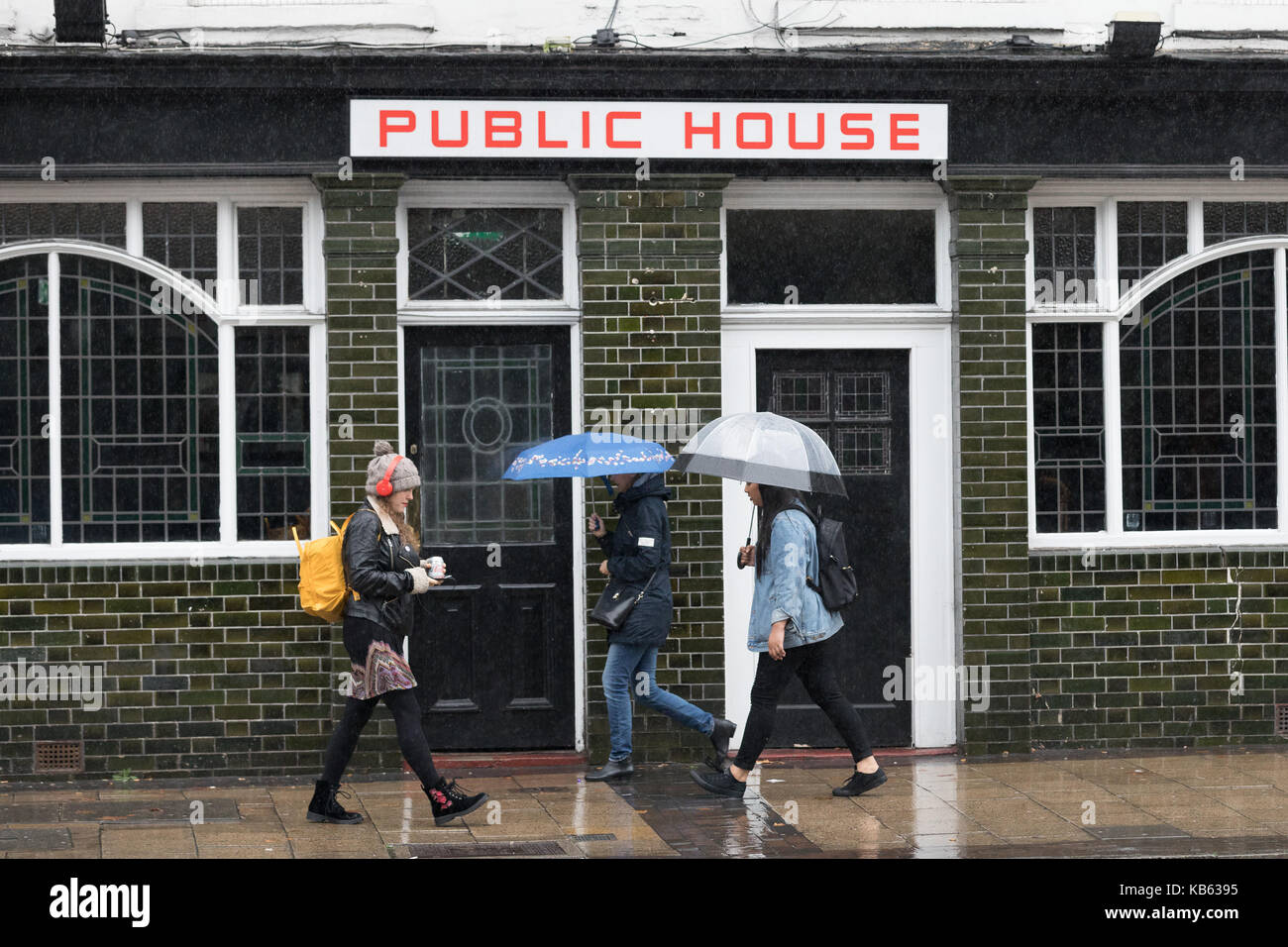 London, UK. 29th September 2017. People with umbrellas walk past a