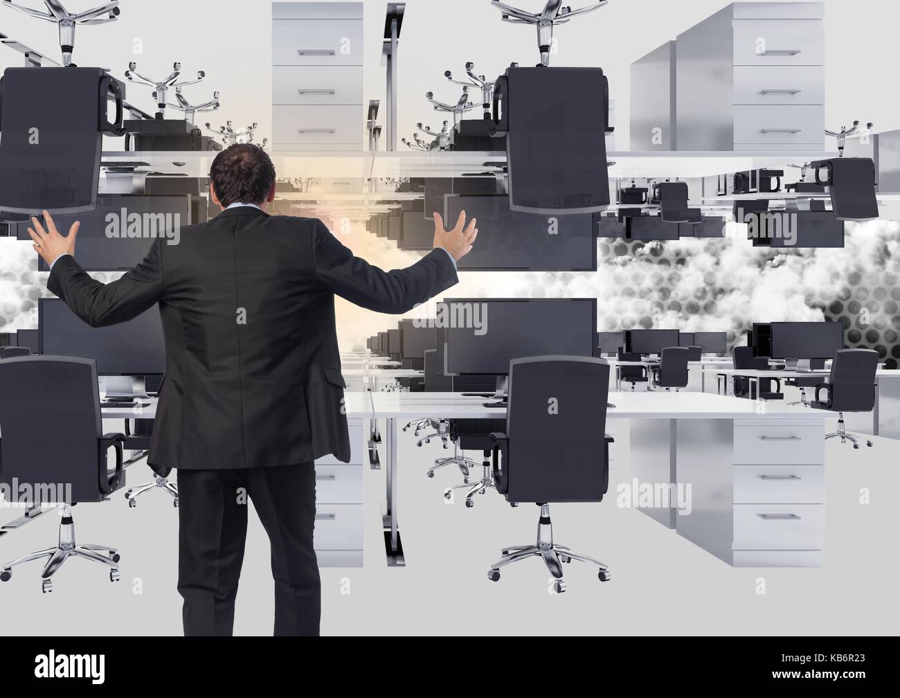 Digital composite of businessman standing in inverted office in clouds with flare Stock Photo