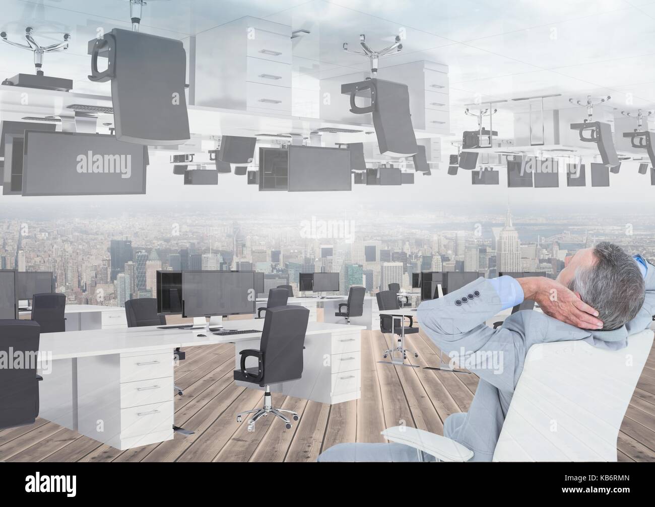 Digital composite of businessman sitting in inverted office with skyline Stock Photo