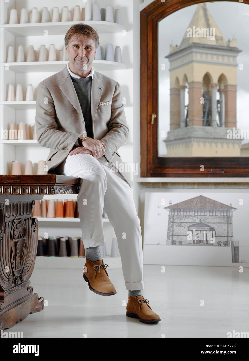 Brunello Cucinelli fashion designer and producer of cashmere clothing portraited in his office