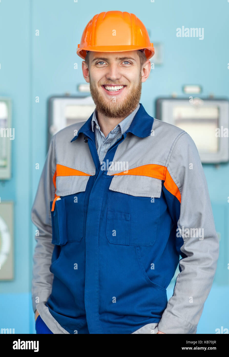 Portrait of young happy engineer in control room in factory Stock Photo