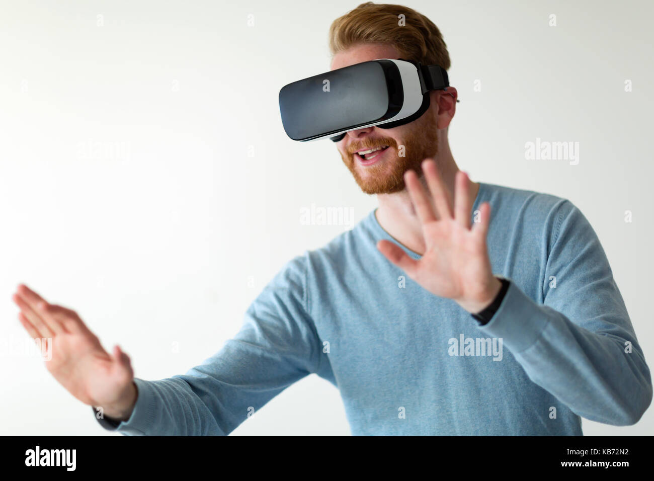 Man wearing virtual reality headset at home Stock Photo - Alamy