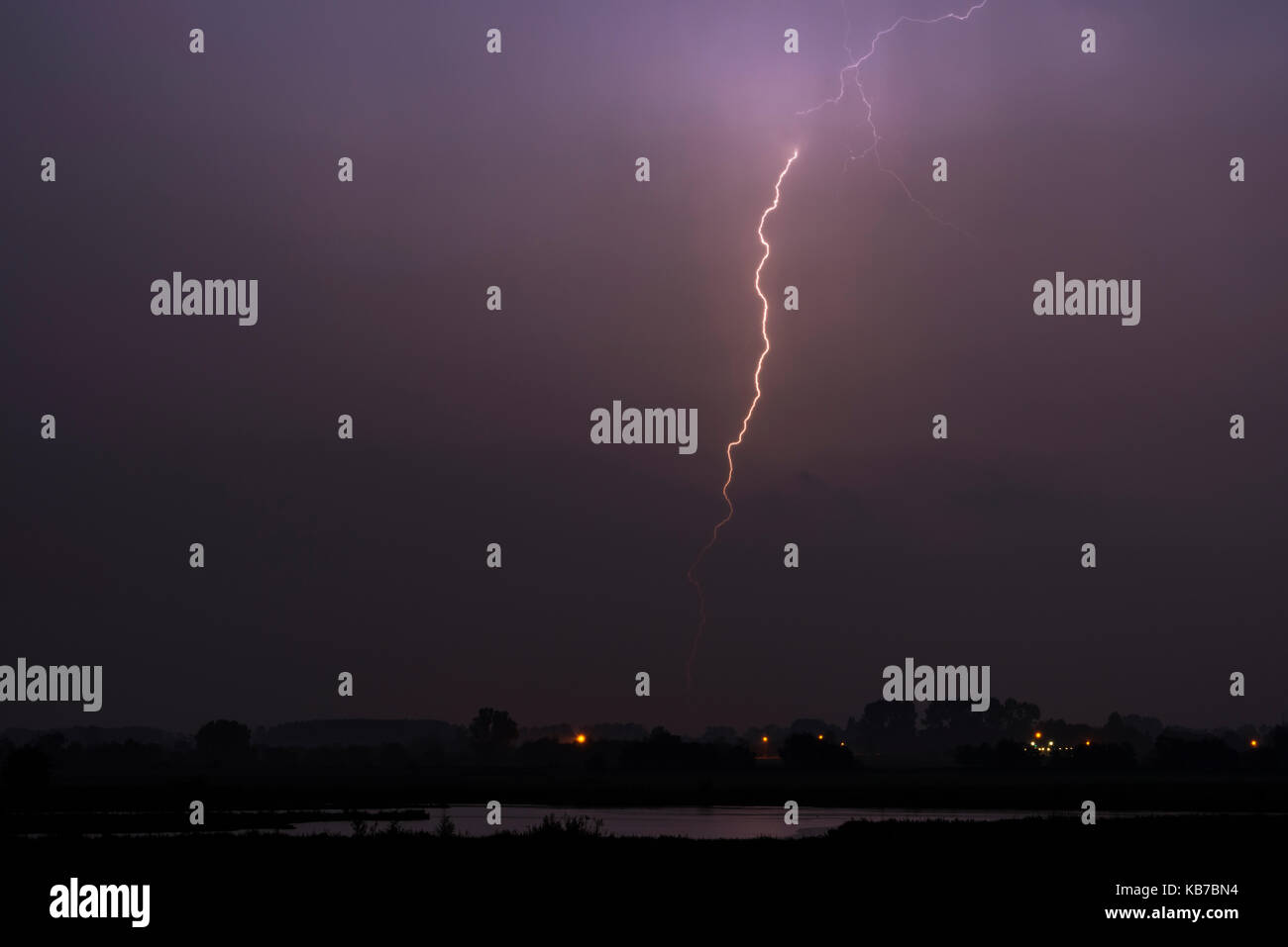A Lightning bolt during a heavy rain shower at night, The Netherlands
