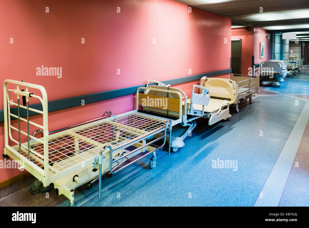 Patient beds being stored in the corridor of a hospital. Stock Photo