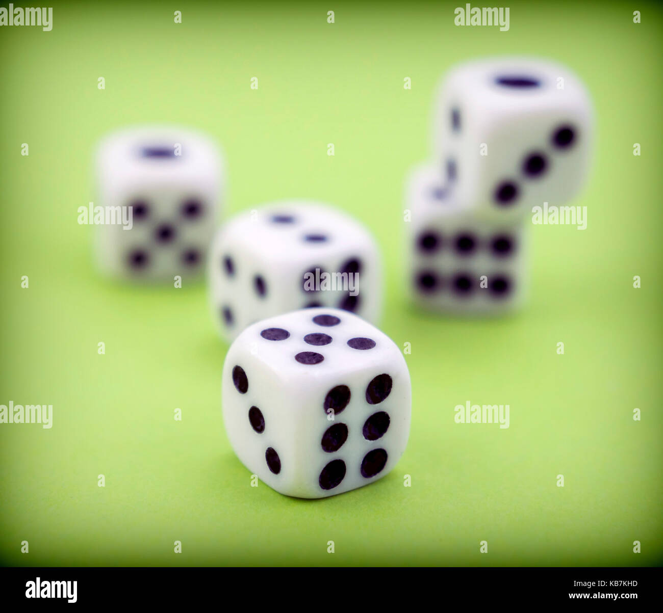 Several dice together isolated on green background Stock Photo