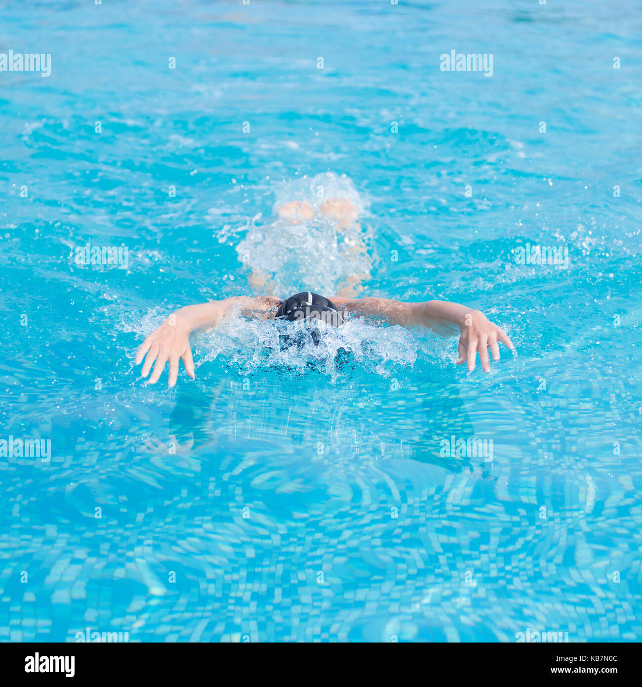 Young girl swimming butterfly stroke style Stock Photo - Alamy