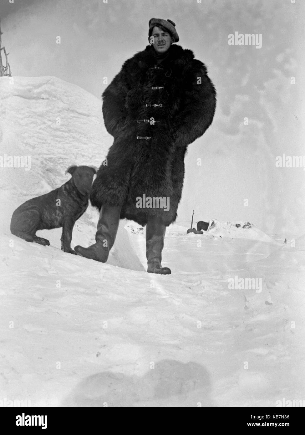 AJAXNETPHOTO. 1903. CANADA, EXACT LOCATION UNKNOWN. - MAN IN HEAVY FUR COAT AND CAP WITH DOG IN THE SNOW. PHOTOGRAPHER:UNKNOWN © DIGITAL IMAGE COPYRIGHT AJAX VINTAGE PICTURE LIBRARY SOURCE: AJAX VINTAGE PICTURE LIBRARY COLLECTION REF:AVL 1873 Stock Photo