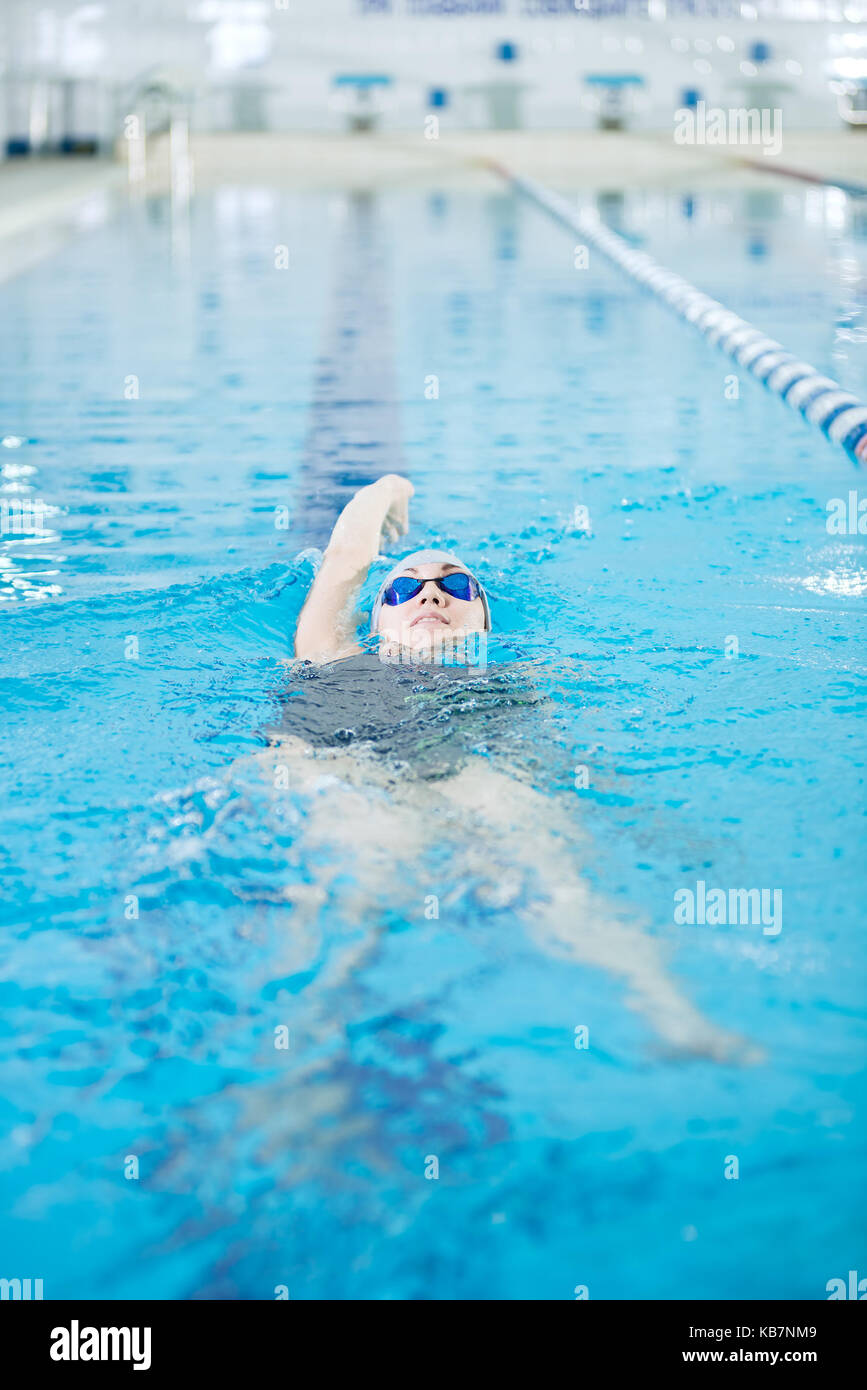 Young girl in goggles swimming back crawl stroke style Stock Photo Alamy