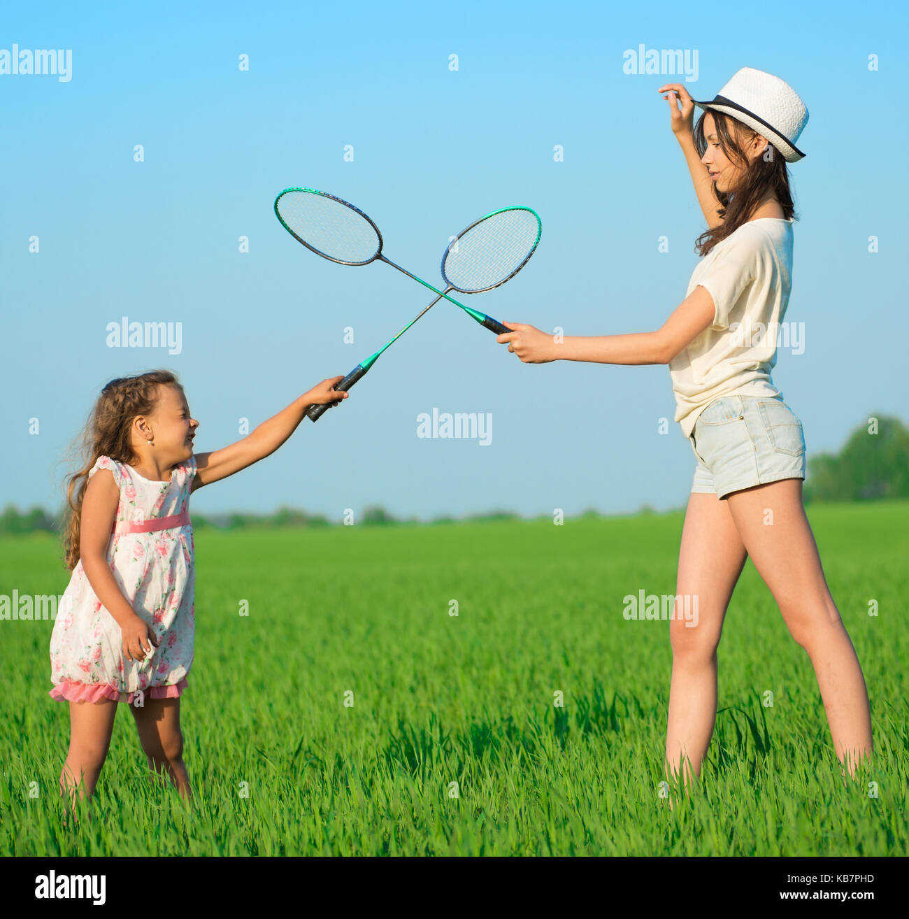 The young girls plays with a racket in badminton Stock Photo Alamy