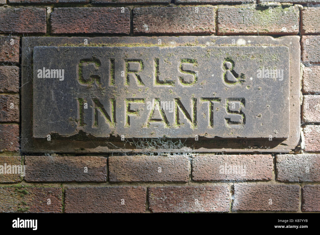 stone carved old vintage school gender signs girls and infants Stock Photo