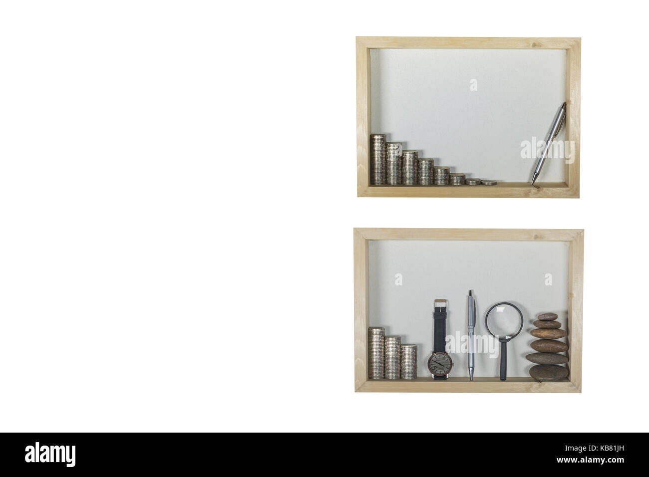 stack coin, pen, magnifying glass and watch in wooden frame isolated on white wall background. Financial and saving concept and copy space. Stock Photo