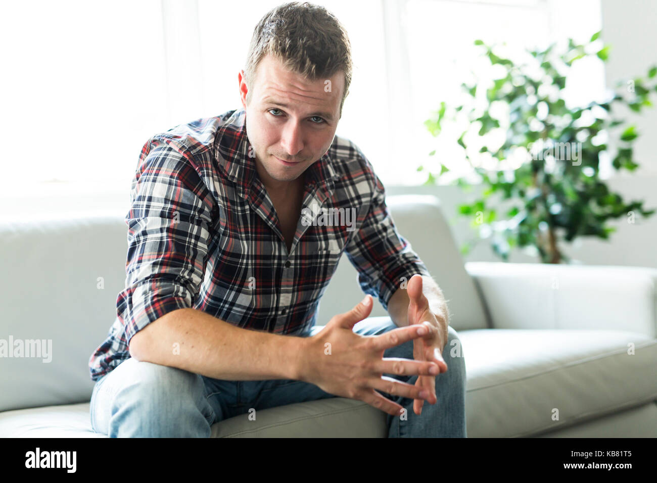 Man sitting in living room Stock Photo