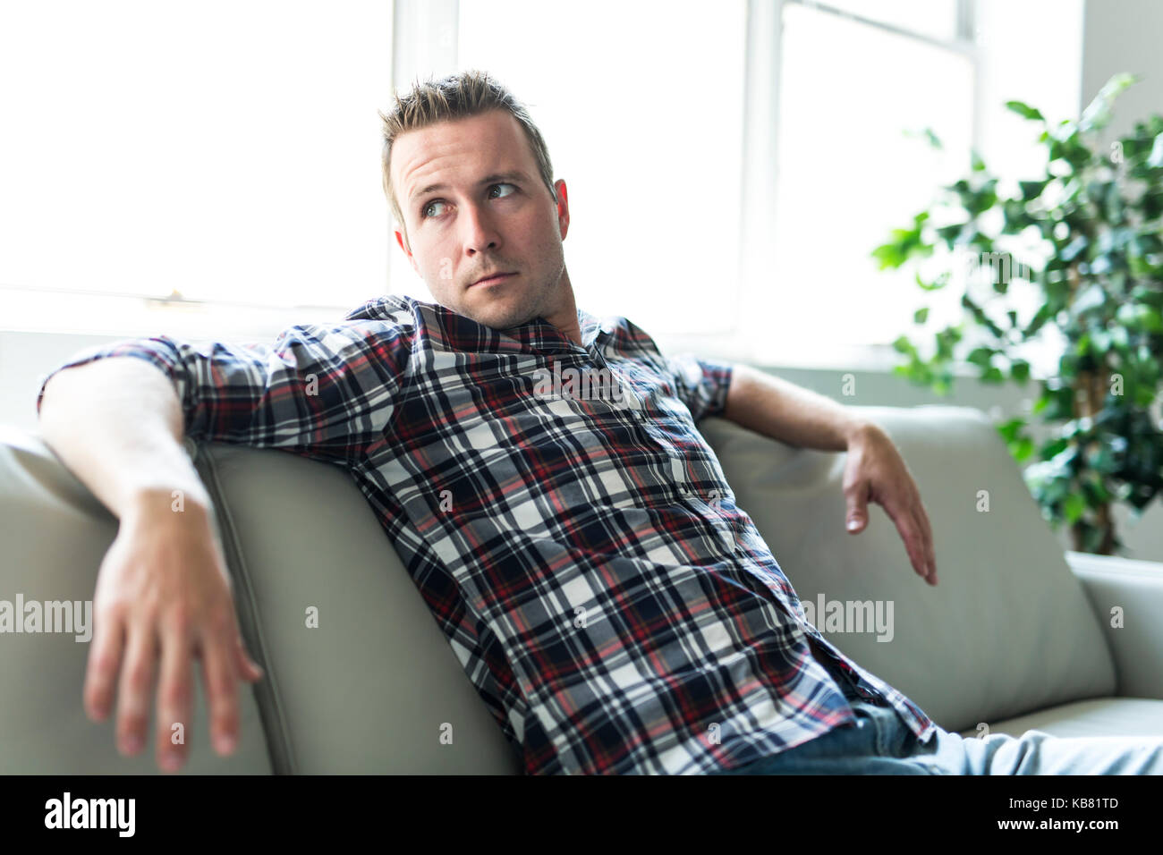 Man sitting in living room Stock Photo