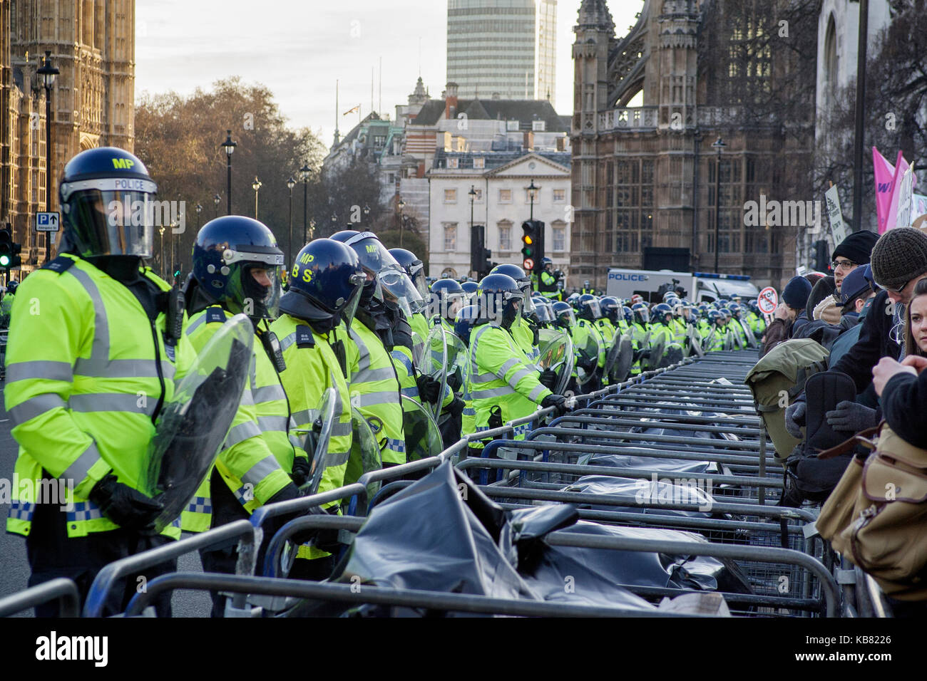 Metropolitan riot police officers carrying shields protect the Houses of  Parliament during student protests against tuition fees London 9/12/2010 Stock Photo