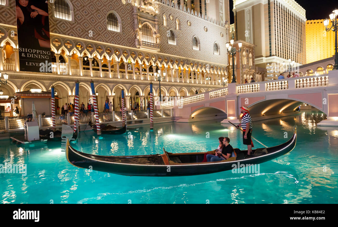 A couple enjoy a ride in a gondola that is offered by The Venetian Hotel in Las Vegas, Nevada. Stock Photo
