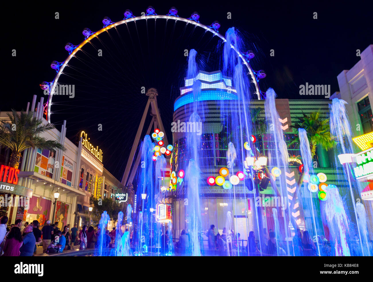 Tourists and visitors are enjoying the nighttime walking around the shoppes and stores next to The High Roller in Las Vegas, Nevada. Stock Photo