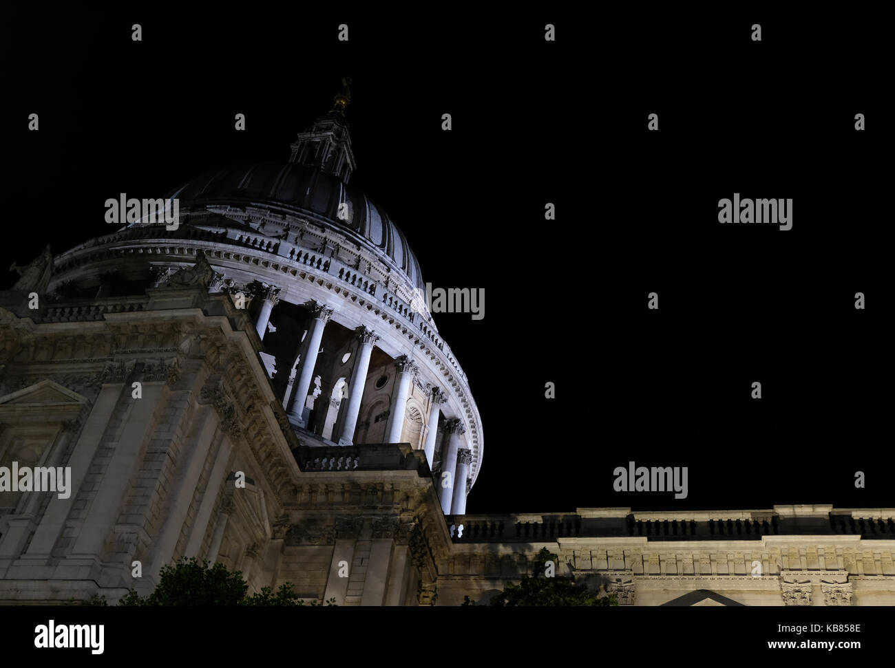 View of the dome of St Paul's Cathedral, London. Dome is illuminated at night. Photo taken from the street below. Stock Photo