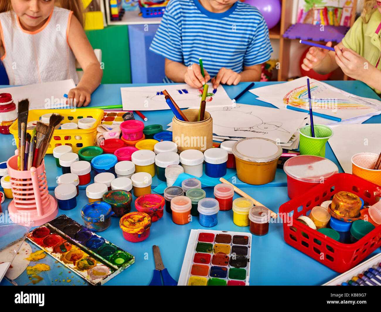 Small students girl and boy painting in art school class Stock Photo ...