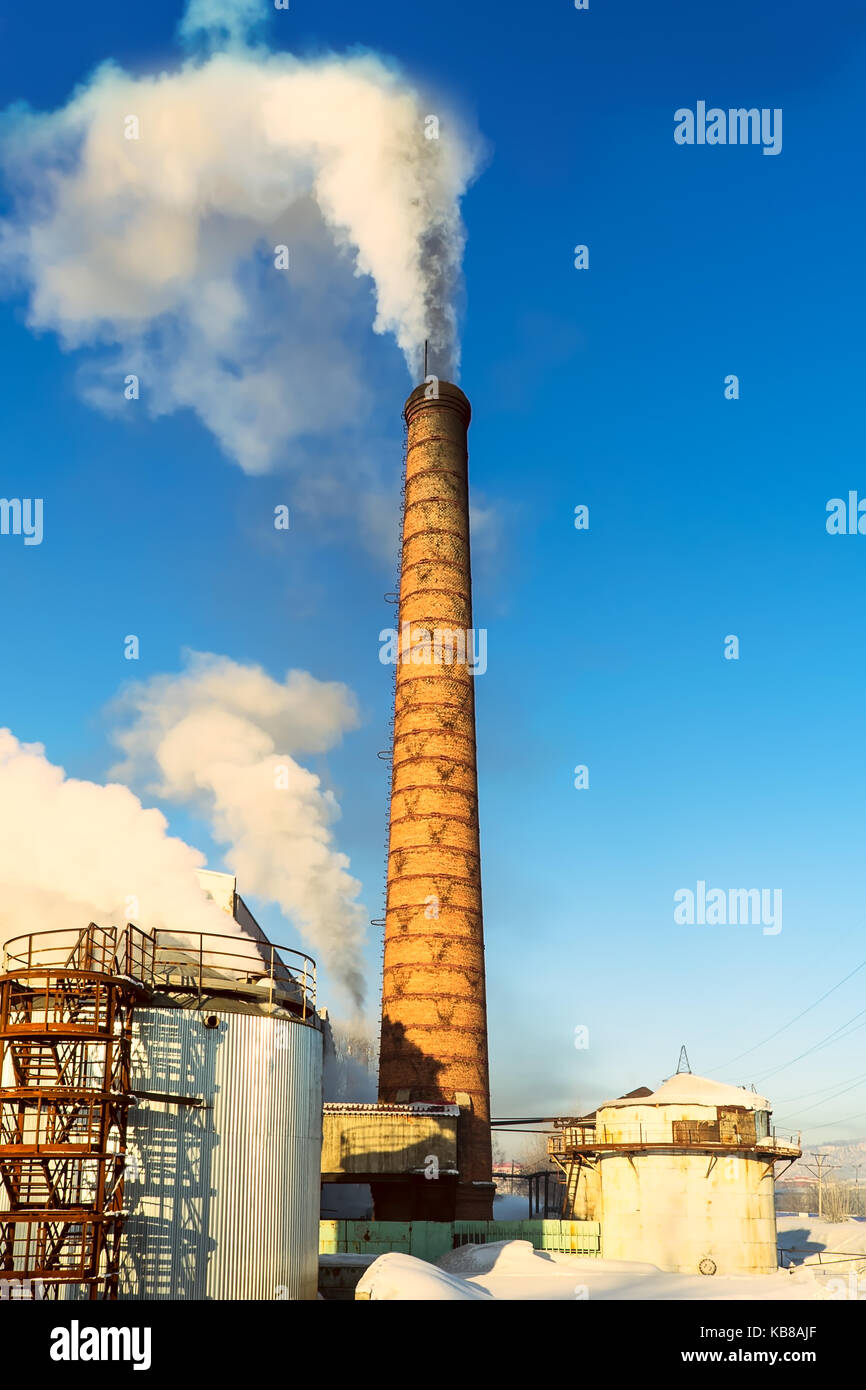 Winter industrial landscape with air pollution pipe. Environmental dust concept. Stock Photo