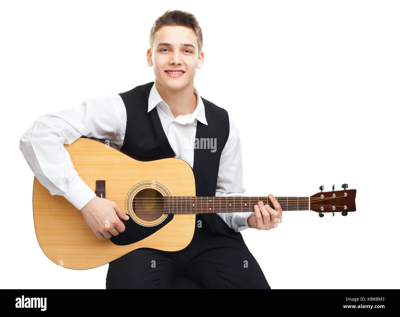 Young man playing on acoustic guitar sitting on a chair isolated on ...