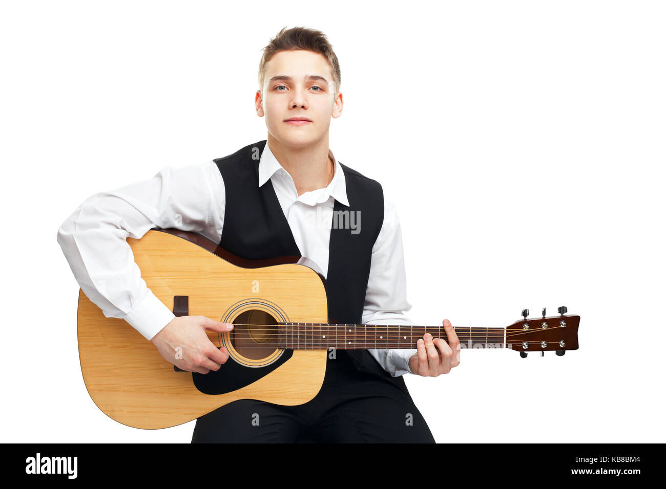 Young man playing on acoustic guitar sitting on a chair isolated on ...