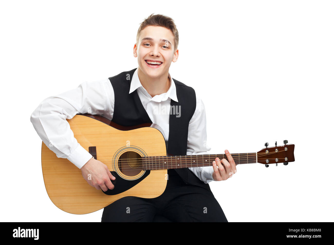 Young man playing on acoustic guitar sitting on a chair isolated on ...
