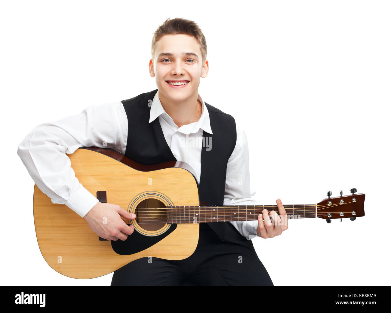 Young man playing on acoustic guitar sitting on a chair isolated on ...