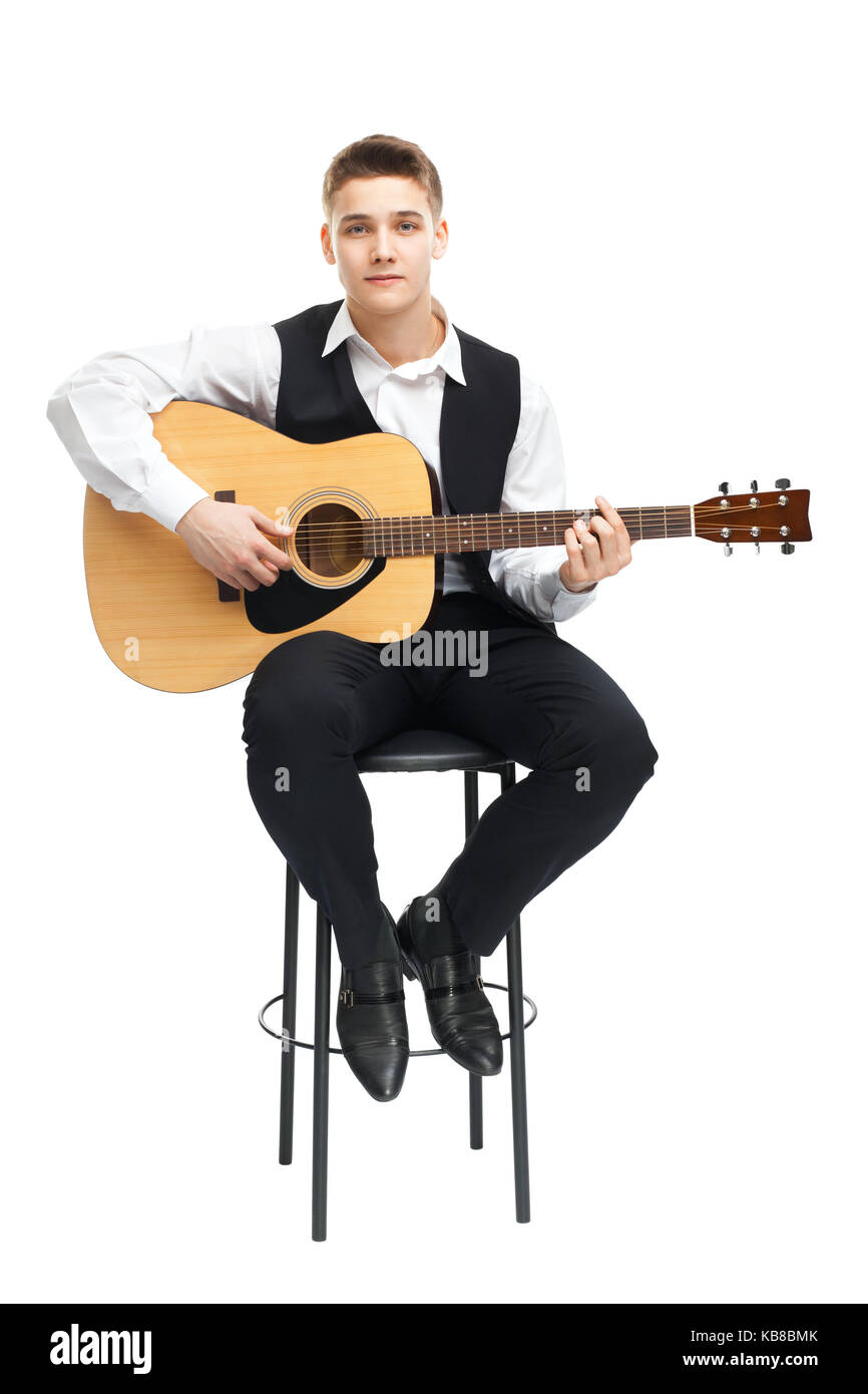 Young man playing on acoustic guitar sitting on a chair isolated on white  background Stock Photo - Alamy