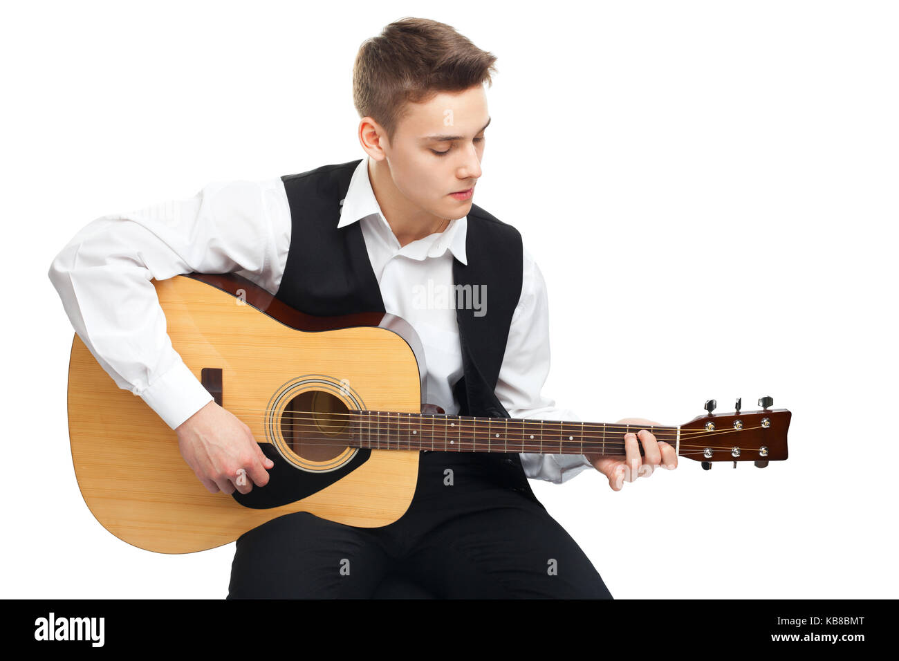 Young man playing on acoustic guitar sitting on a chair isolated on ...