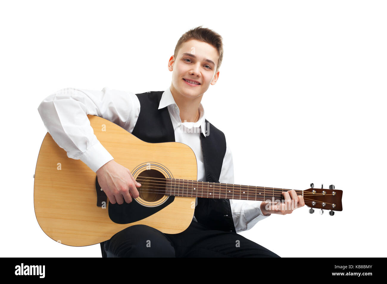 Young man playing on acoustic guitar sitting on a chair isolated on ...