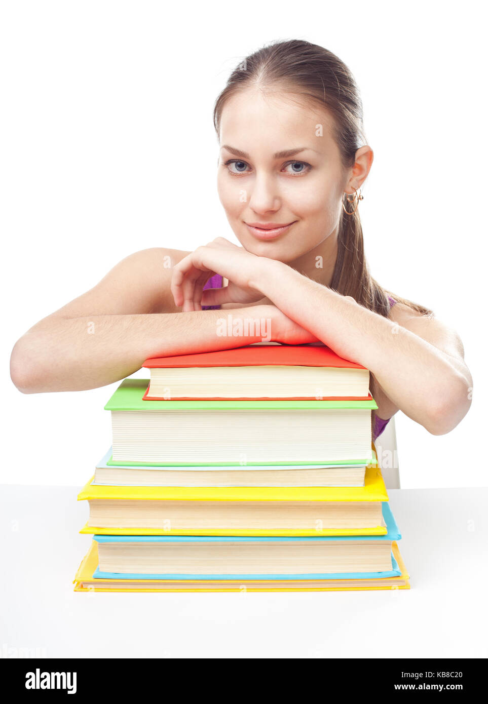 Portrait of pretty young happy smiling student girl with pile of books ...